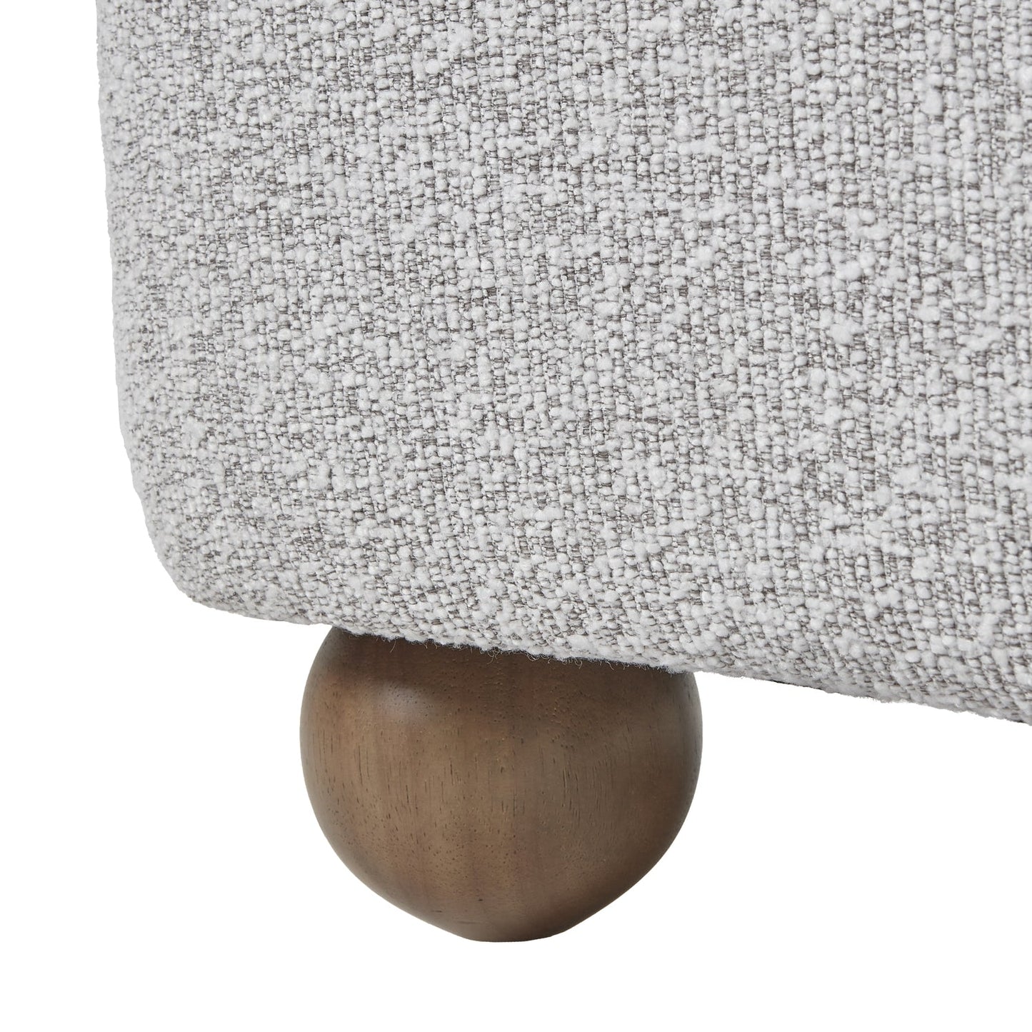 Lounge armchair with rounded arms and upholstered seat, foot detail