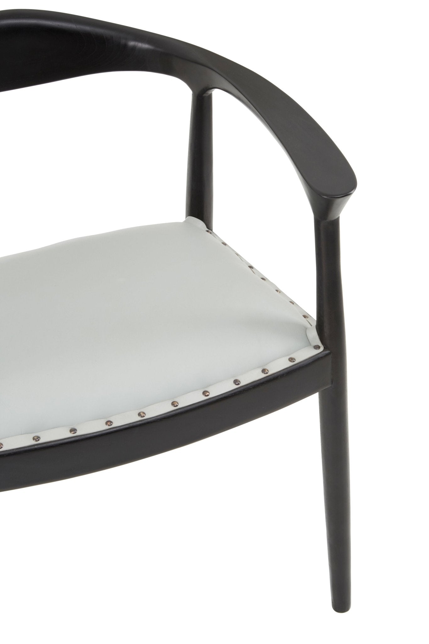 Teak wood dining chair with tan leather seat and stud detailing, detail