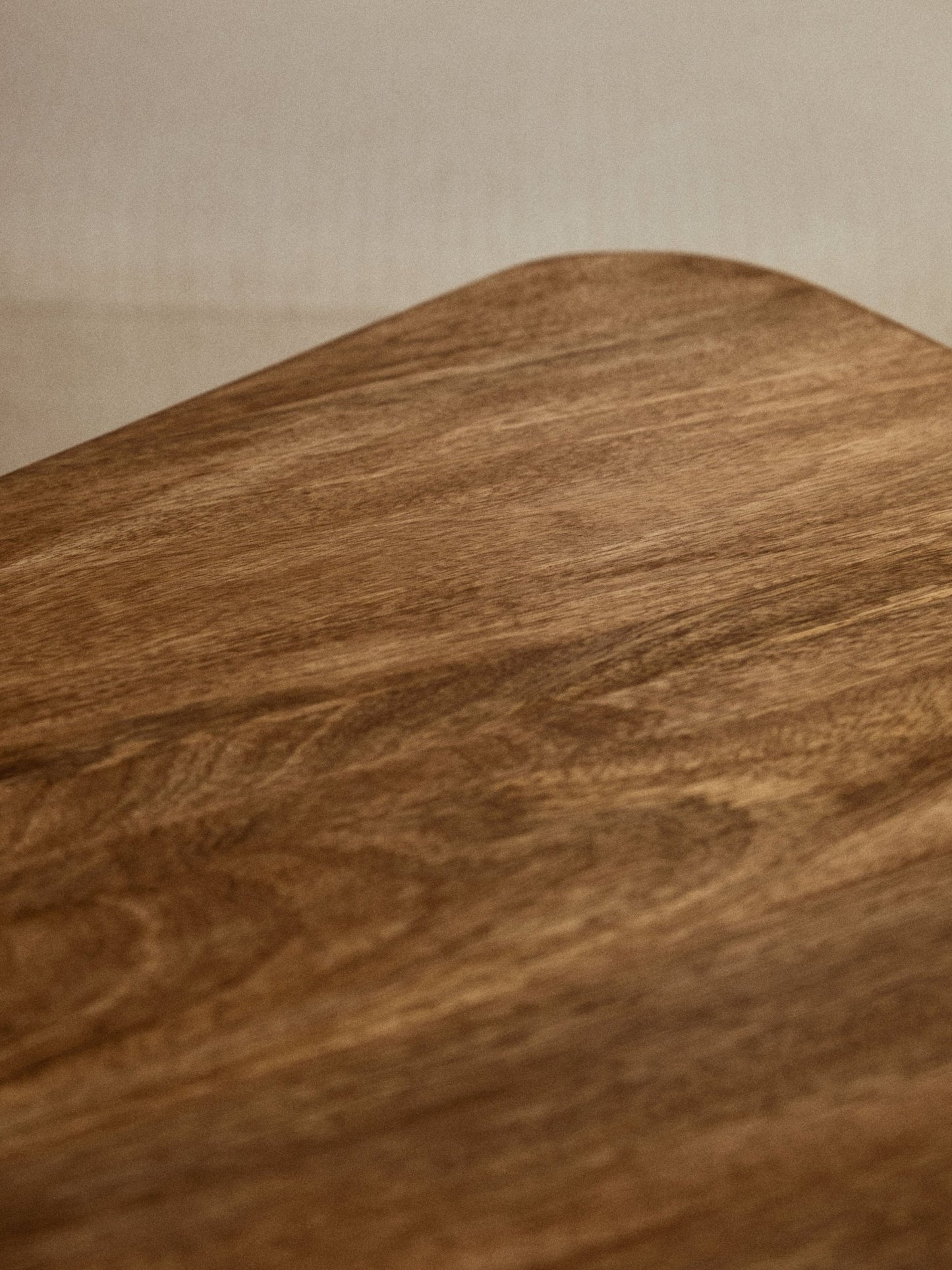 Coffee table styled in a calm, modern living space, close up wood grain top view