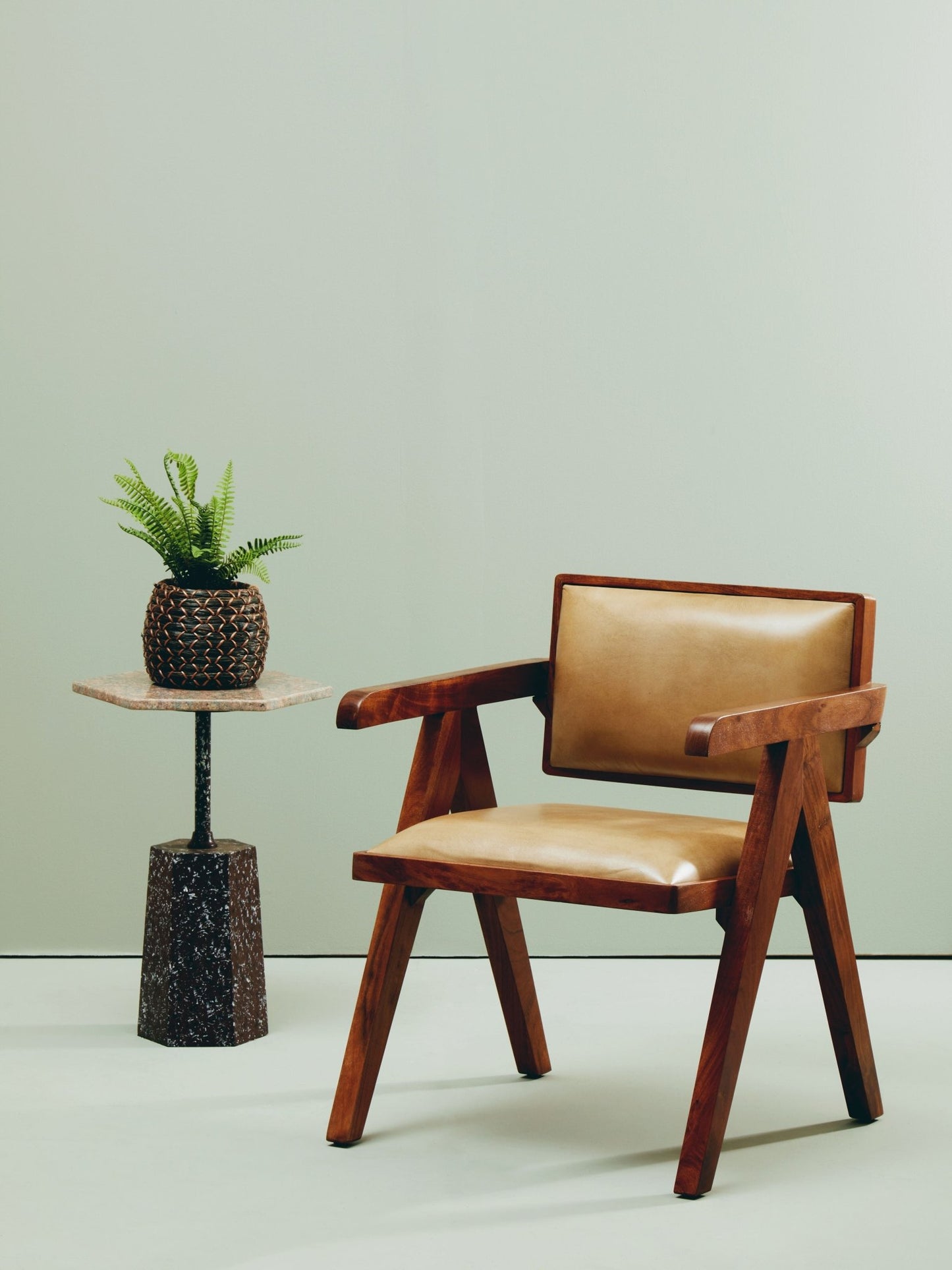 Wooden armchair with leather seat in a warm, neutral interior