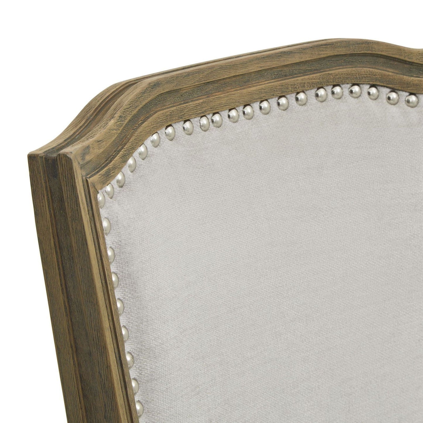 Grey upholstered dining chair with carved wooden frame and stud edging, top edge detail