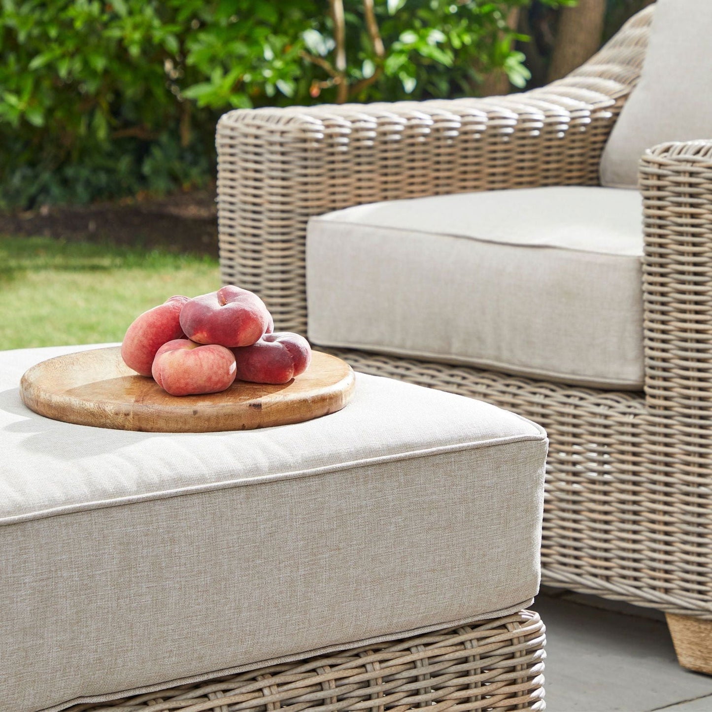 Footstool styled in an outdoor lounge setting, close up