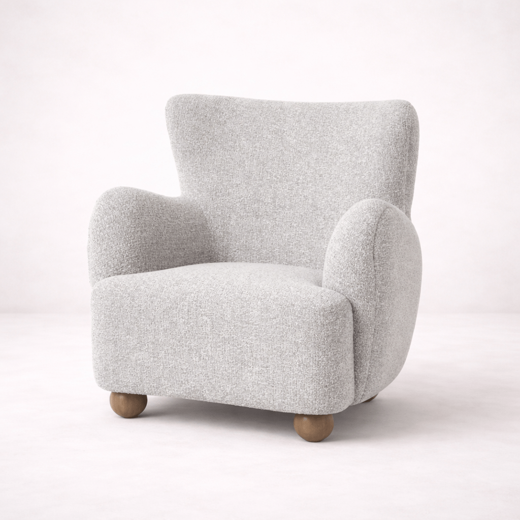 Upholstered armchair with rounded arms and soft textured fabric finish