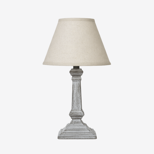 Column table lamp with weathered base and neutral fabric shade
