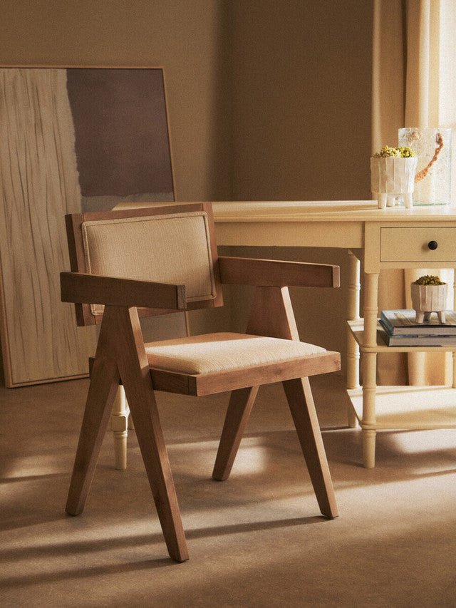 Scandinavian armchair in grey wash beech with ivory upholstery in a calm interior setting
