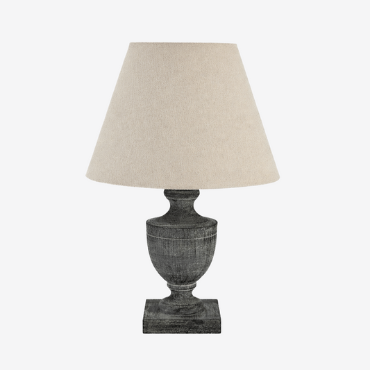 Urn shaped wooden table lamp with dark finish and neutral shade