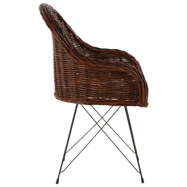 Rattan armchair with curved back and slim metal legs, side view