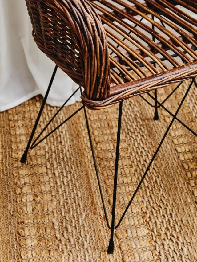 Rattan armchair in a relaxed, natural dining setting