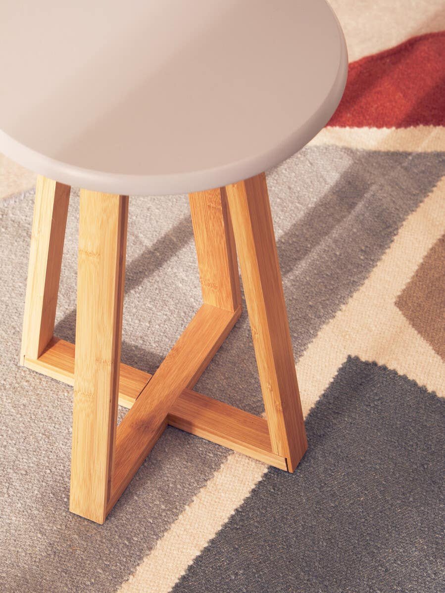 Stool in a calm, contemporary interior setting, seat close up